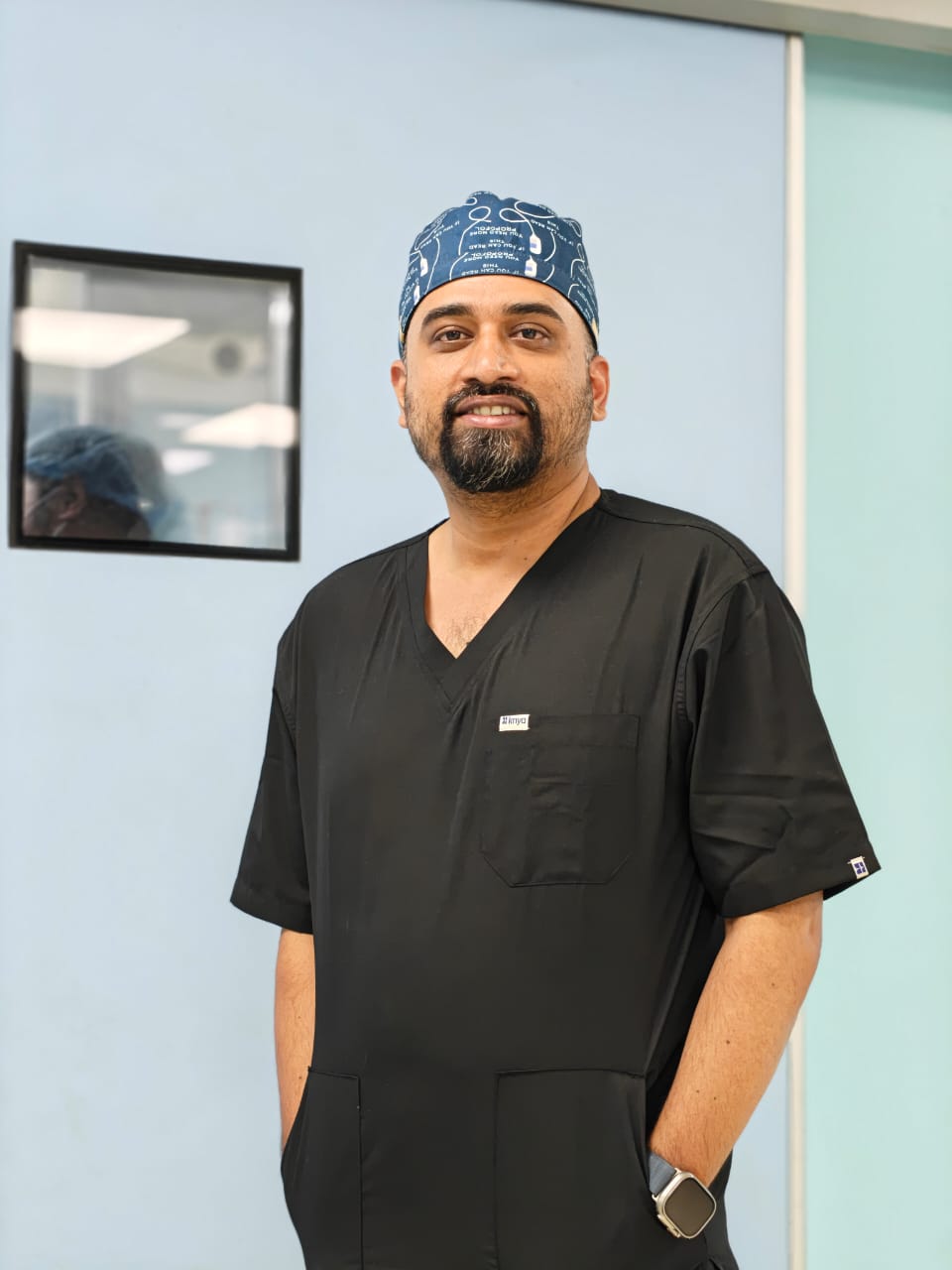 Dr. Deepak in black scrubs